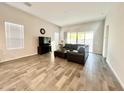 Spacious living room with modern flooring, stylish sectional sofa, and bright natural light at 18100 N Piccolo Dr, Maricopa, AZ 85138