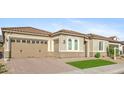 Stylish home features a well-maintained desert landscape, two-car garage, and a tiled roof at 19045 N 269Th Dr, Buckeye, AZ 85396