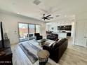 Open-concept living room showcasing tile floors, modern ceiling fan, and backyard access at 20171 W Cheery Lynn Rd, Buckeye, AZ 85396