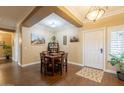 Cozy dining area featuring wood floors, a table with four chairs, and decorative wall art at 21231 E Nightingale Rd, Queen Creek, AZ 85142