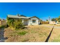 Inviting single-story home boasting a covered porch, xeriscaped yard, and a mature citrus tree at 214 W June Cir, Mesa, AZ 85201