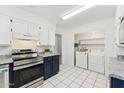 Well-lit kitchen featuring stainless steel appliances and a laundry area at 2395 S Arizona Rd, Apache Junction, AZ 85119