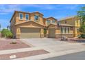 Two-story home featuring a two-car garage, well-maintained landscaping, and a basketball hoop in the driveway at 3436 E Gary Way, Gilbert, AZ 85234