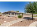 Single-story home with desert landscaping, stone accents, and a two-car garage, a great curb appeal at 4100 S Dewdrop Ct, Gilbert, AZ 85297
