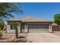 Single-story home with desert landscaping, neutral color scheme, a two-car garage, and a tiled roof at 4100 S Dewdrop Ct, Gilbert, AZ 85297