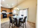 Eat in kitchen area with pendant lighting and sliding door at 44147 W Snow Dr, Maricopa, AZ 85138