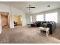 Bright living room with neutral carpet, offering a flexible space for relaxation and entertainment at 44147 W Snow Dr, Maricopa, AZ 85138