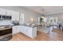 Open concept kitchen with stainless steel appliances and breakfast bar, leading to the dining and living area at 4438 N 27Th St # 27, Phoenix, AZ 85016