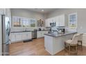 Bright kitchen with white cabinetry, stainless steel appliances, and a breakfast bar area at 4438 N 27Th St # 27, Phoenix, AZ 85016