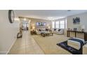 Spacious living room featuring neutral paint, carpet, and elegant furnishings at 46057 W Dutchman Dr, Maricopa, AZ 85139