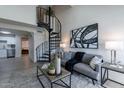 Open-concept living room boasts a spiral staircase and flows into the kitchen and bedroom at 4901 S Calle Los Cerros Dr # 237, Tempe, AZ 85282
