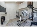 Spacious living room with spiral staircase, fireplace, and open access to the kitchen at 4901 S Calle Los Cerros Dr # 237, Tempe, AZ 85282