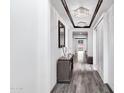 Elegant hallway features hardwood floors, wainscotting, stylish light fixtures, and tasteful decor at 5223 S Axiom --, Mesa, AZ 85212