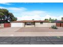 Inviting single-story home featuring a front yard and a two-car garage at 612 N Recker Rd, Mesa, AZ 85205