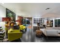 Spacious living room with modern furniture, fireplace, and seamless indoor-outdoor flow to the pool at 6417 N 52Nd Pl, Paradise Valley, AZ 85253