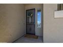 Inviting front entrance with a decorative wreath and a secure screen door at 6422 W Brookhart Way, Phoenix, AZ 85083