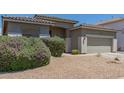 Landscaped front yard showcasing desert landscaping and a charming home exterior at 6422 W Brookhart Way, Phoenix, AZ 85083