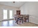 Cozy dining room with wood-look tile, featuring a rustic wood table with seating for six and bright, natural light at 7125 W Canterbury Dr, Peoria, AZ 85345