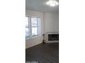 Bright living room with a cozy fireplace, ample natural light, and elegant dark wood-look floors at 7977 W Wacker Rd # 253, Peoria, AZ 85381
