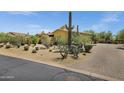 Desert home with mature landscaping and a circular driveway at 9290 E Thompson Peak Pkwy # 409, Scottsdale, AZ 85255