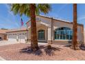 Charming single-story home featuring desert landscaping, palm trees, and shutters at 9566 E Plana Ave, Mesa, AZ 85212