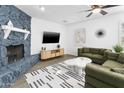 Bright living room featuring a cozy fireplace, modern furnishings, and a spacious layout at 1098 E Fremont Dr, Tempe, AZ 85282