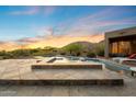 Relaxing backyard pool and patio area with mountain views at sunset at 11986 N 134Th Pl, Scottsdale, AZ 85259