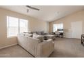 Spacious living room with neutral carpet, ample natural light, and a cozy sectional sofa at 12208 N 41St Ln, Phoenix, AZ 85029