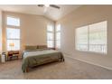Bright main bedroom featuring neutral carpet, multiple windows, a ceiling fan, and ample natural light at 12208 N 41St Ln, Phoenix, AZ 85029