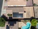 Aerial view of the house showcasing a swimming pool and installed solar panels on the roof at 12934 W Voltaire Ave, El Mirage, AZ 85335