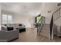 Bright open-concept living room and dining room featuring a staircase at 13993 N 102Nd St, Scottsdale, AZ 85260