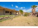 Expansive backyard showcasing its potential, featuring tropical trees, but needing some TLC at 1407 W Utopia Rd, Phoenix, AZ 85027