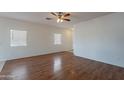 Bright living room with wood floors, neutral walls, and plenty of natural light at 14244 N 132Nd Ln, Surprise, AZ 85379