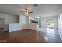 Spacious living area featuring wood flooring, neutral walls, and a ceiling fan at 14244 N 132Nd Ln, Surprise, AZ 85379