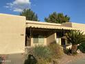 Charming single-story home features desert landscaping and a covered porch in a well-kept community at 14300 W Bell Rd # 57, Surprise, AZ 85374