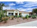 Charming single-story home featuring desert landscaping with cacti and a tile roof under a partly cloudy sky at 14605 S 35 Pl, Phoenix, AZ 85044