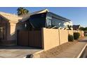 Home exterior displaying RV behind privacy wall, gated entrance, and desert landscaping at 1523 E Tulsa St, Chandler, AZ 85225