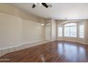 Open living room features beautiful wood floors, neutral walls, and plenty of natural light at 15642 N Naegel Dr, Surprise, AZ 85374