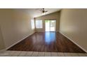 Bright living room featuring wood floors, large windows, and a sliding door to the back at 15642 N Naegel Dr, Surprise, AZ 85374
