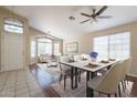 Bright living room with wood floors, ceiling fan, and dining table set for six at 15642 N Naegel Dr, Surprise, AZ 85374