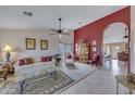 Elegant living room with neutral walls, tile floor, ceiling fan, and arched doorway, providing a bright atmosphere at 16230 E Glenpoint Dr, Fountain Hills, AZ 85268