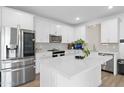 Bright kitchen featuring white cabinetry, stainless steel appliances, and a center island at 16956 W Alice Ave, Waddell, AZ 85355