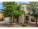 Inviting front exterior showcasing a well-maintained yard and a charming facade with mature trees at 18563 W Fairway Dr, Surprise, AZ 85374