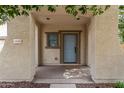 A cozy front porch features a stylish entrance door and complementary architectural details at 18563 W Fairway Dr, Surprise, AZ 85374