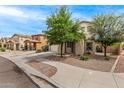 Traditional two-story home with tidy landscaping and a sidewalk leading to the front door at 18563 W Fairway Dr, Surprise, AZ 85374