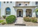 Charming front entrance with stone pathway, desert landscaping, and elegant columns at 1890 E Sagittarius Pl, Chandler, AZ 85249