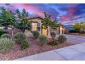 Beautiful one-story home with desert landscaping, brick driveway, and a peek of the sky beyond at 19873 W San Juan Ave, Litchfield Park, AZ 85340