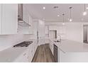 Bright kitchen featuring white cabinets, stainless steel appliances, a subway tile backsplash, and a spacious island at 20274 W Monterey Way, Buckeye, AZ 85396