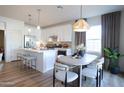 Bright eat-in kitchen featuring white cabinets, stainless steel appliances, and a cozy dining area at 2205 N Peden Dr, Chandler, AZ 85225