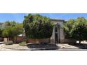 Exterior view showcasing the home's architectural style, mature trees, and well-maintained landscaping at 2308 S Bernard --, Mesa, AZ 85209